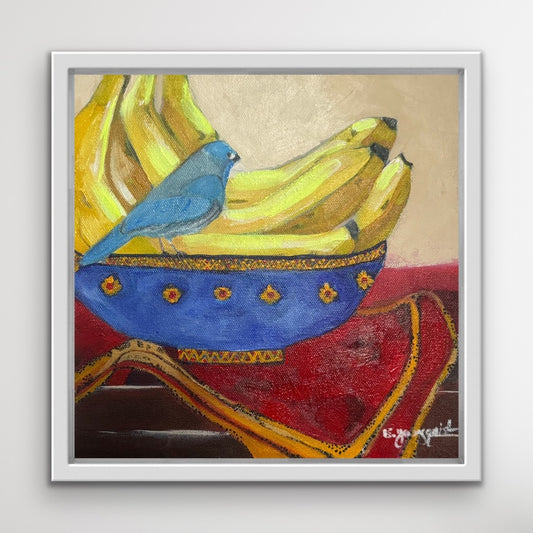 Framed artwork of a blue bird on bananas with a colorful background for interior design and home decor
