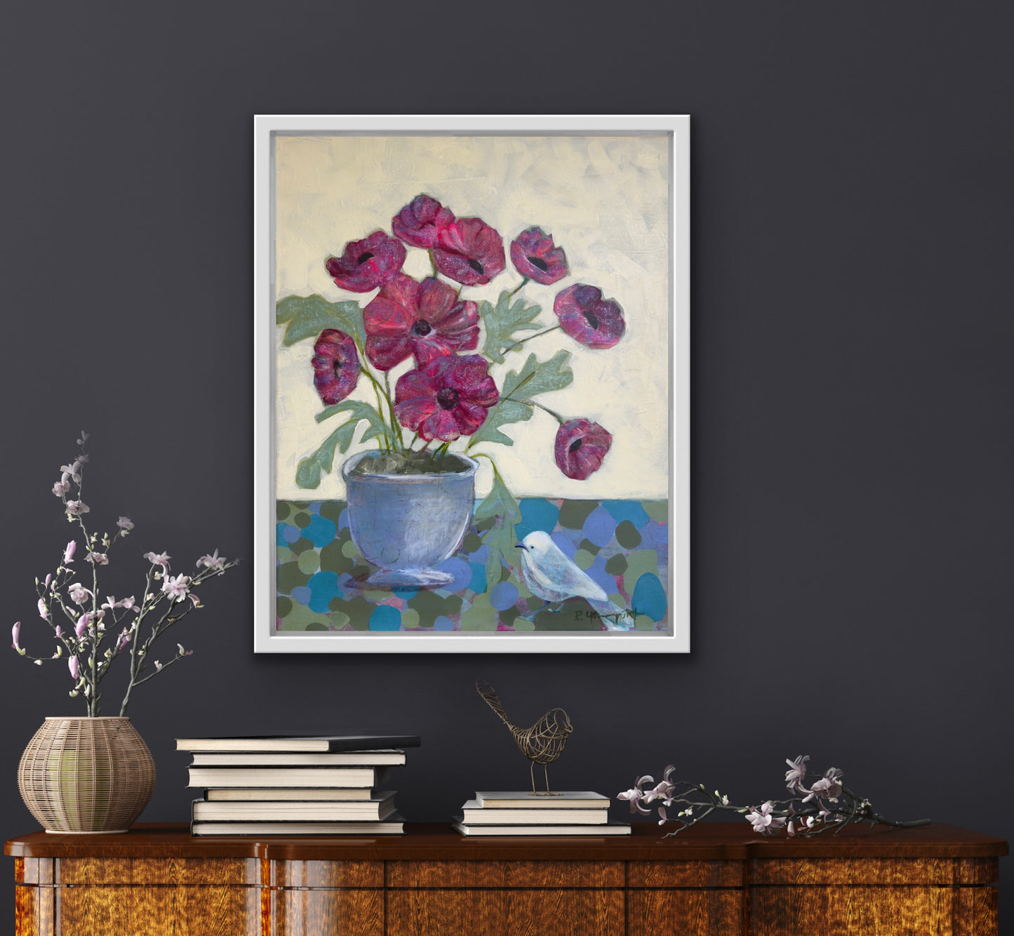 Framed floral artwork on a dark wall with decorative items below for art collectors and home decor