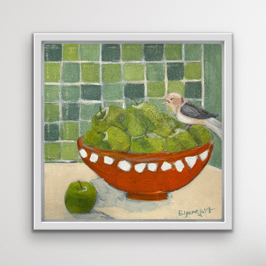 original acrylic framed artwork of a bird perched on a bowl of green apples against a green tiled wall kitchen decor