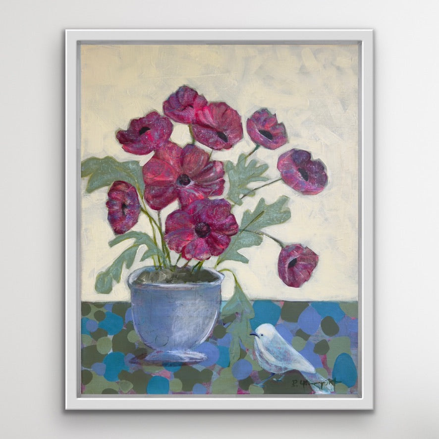 Framed artwork of red flowers in a blue pot with a white bird on a light gray background