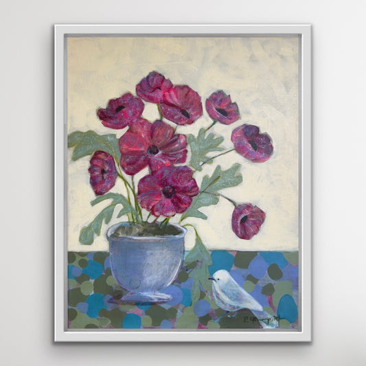 Framed artwork of red flowers in a blue pot with a white bird on a light gray background