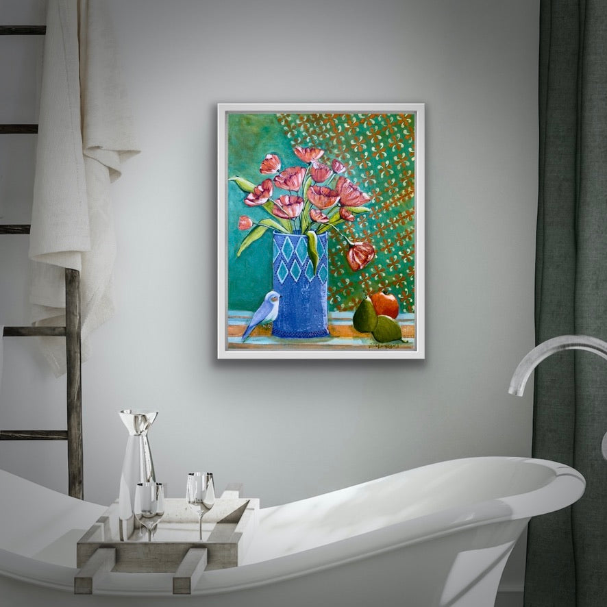 Framed artwork of flowers and a blue vase on a bathroom wall above a bathtub for home decor