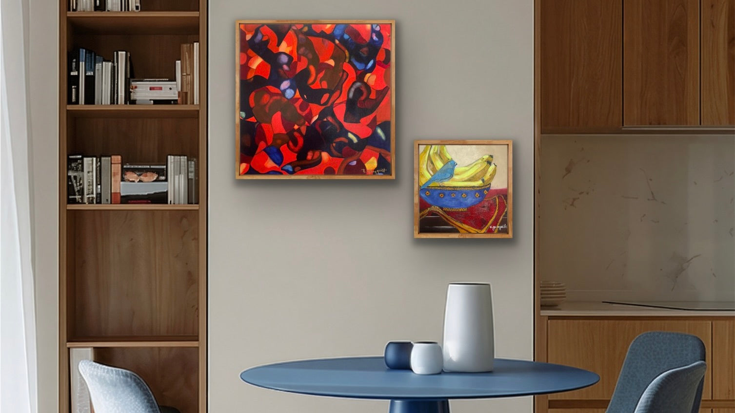 Modern kitchen interior with a round blue table, colorful abstract painting, still life on the wall, and a bookshelf.