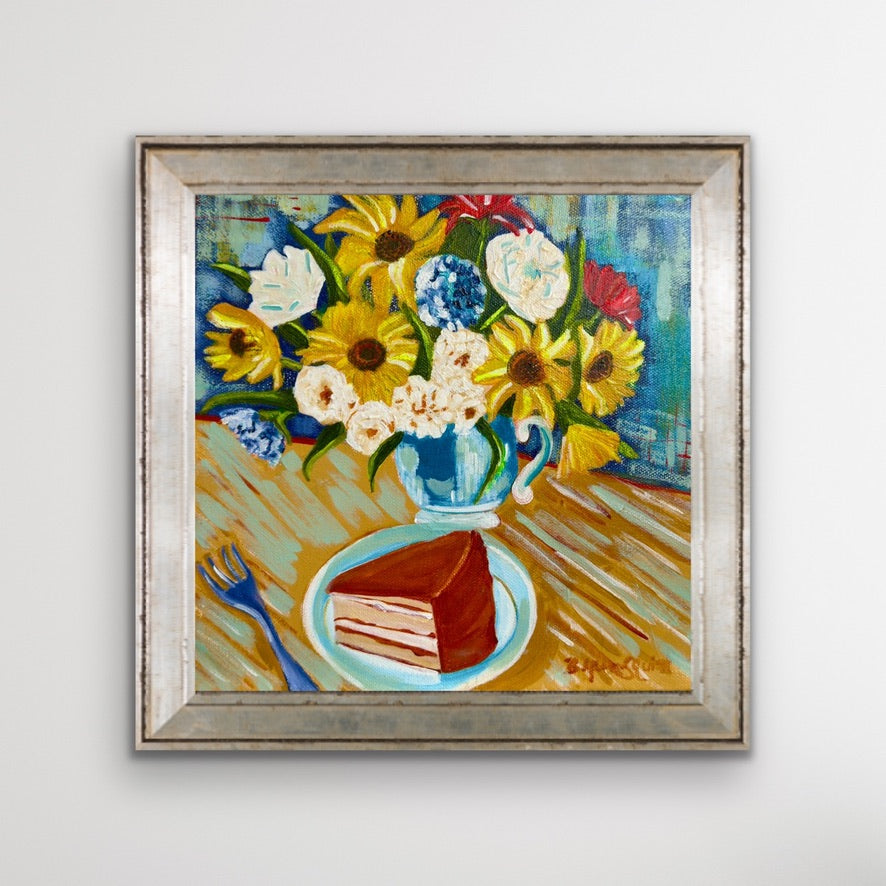 Framed painting of a still life with flowers and cake on a table.