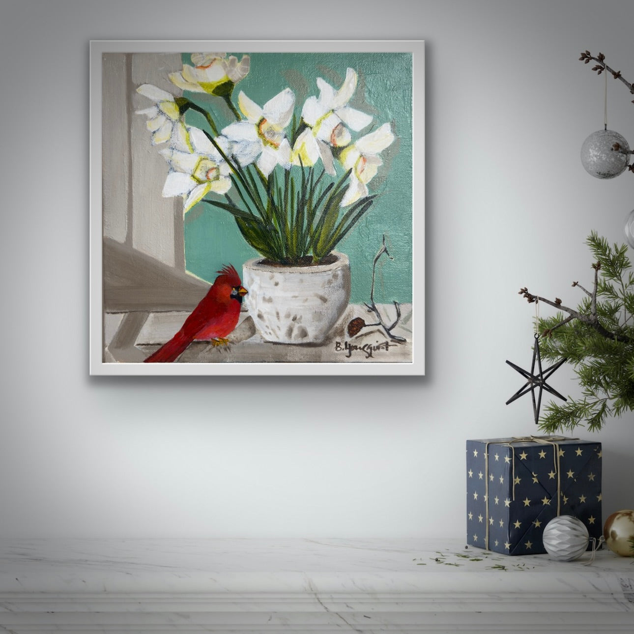 Framed artwork of a cardinal and white flowers in winter.